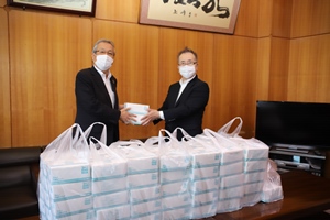 ジスコホテル徳永社長様からマスクの寄贈を受ける市長の写真